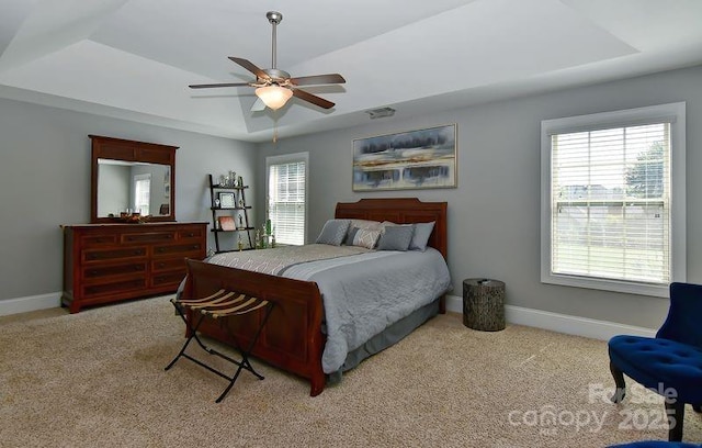3913 Widgeon Way, Waxhaw, NC 28173 - bedroom featuring a tray ceiling, light colored carpet, and ceiling fan