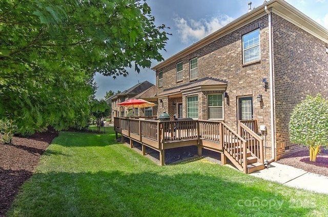 3913 Widgeon Way, Waxhaw, NC 28173 - rear view of house featuring brick siding, a lawn, and a deck