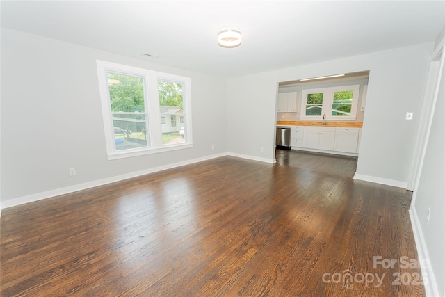 1208 Martin Luther King Ave, Kannapolis, NC 28083 - unfurnished living room with plenty of natural light and dark wood-style flooring