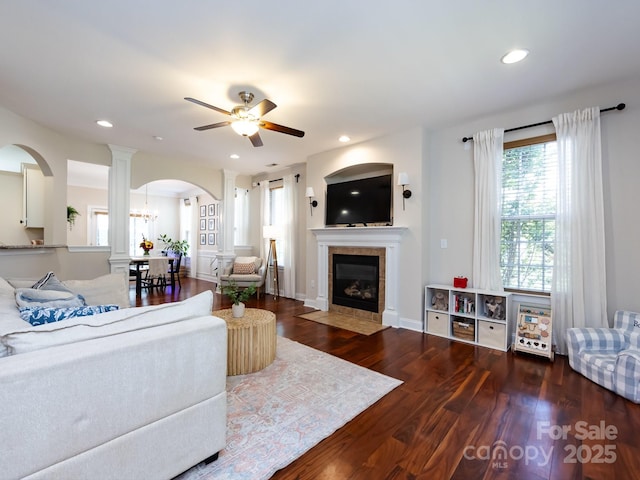 12928 Windy Lea Ln, Huntersville, NC 28078 - living area with arched walkways, a tiled fireplace, ceiling fan, wood finished floors, and recessed lighting