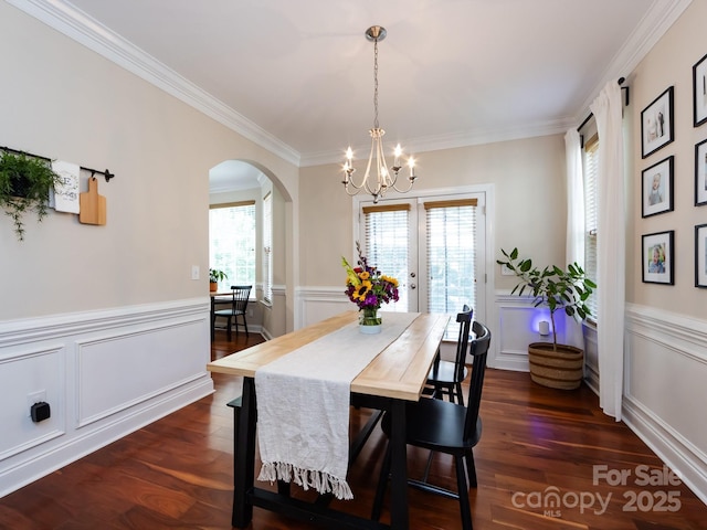 12928 Windy Lea Ln, Huntersville, NC 28078 - dining room with arched walkways, a chandelier, ornamental molding, a wainscoted wall, and a decorative wall