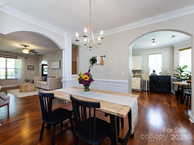 12928 Windy Lea Ln, Huntersville, NC 28078 - dining room with arched walkways, dark wood-type flooring, crown molding, ceiling fan, and a chandelier