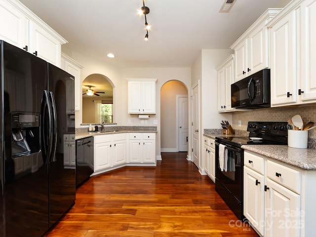 12928 Windy Lea Ln, Huntersville, NC 28078 - kitchen featuring black appliances, arched walkways, tasteful backsplash, a ceiling fan, and white cabinets
