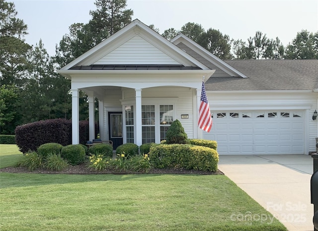 919 Lily Magnolia Ct, Fort Mill, SC 29707 - view of front of house featuring an attached garage, a front yard, concrete driveway, covered porch, and roof with shingles