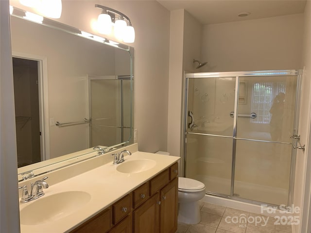 919 Lily Magnolia Ct, Fort Mill, SC 29707 - bathroom with tile patterned floors, a stall shower, double vanity, and a spacious closet