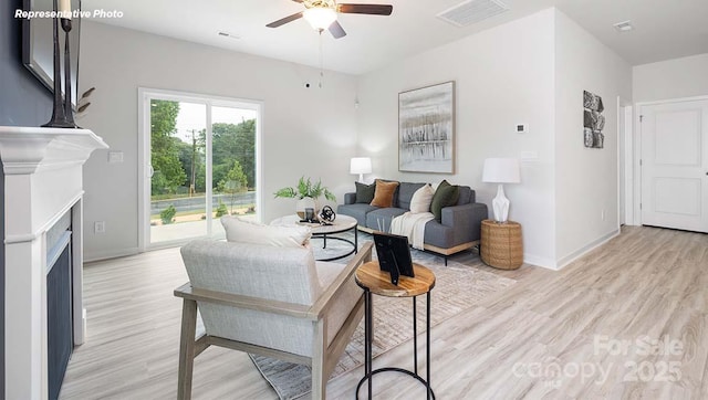 12020 Zazu Way, Charlotte, NC 28215 - living room featuring ceiling fan, light wood finished floors, and a fireplace