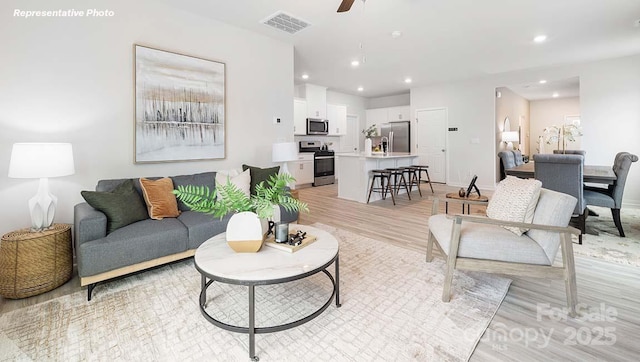 12020 Zazu Way, Charlotte, NC 28215 - living room featuring light wood finished floors, ceiling fan, and recessed lighting