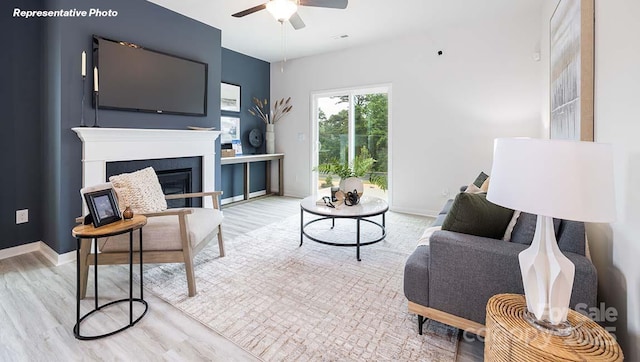 12020 Zazu Way, Charlotte, NC 28215 - living area with ceiling fan, wood finished floors, and a glass covered fireplace