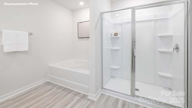 12020 Zazu Way, Charlotte, NC 28215 - full bathroom featuring wood finished floors, a stall shower, a garden tub, and recessed lighting