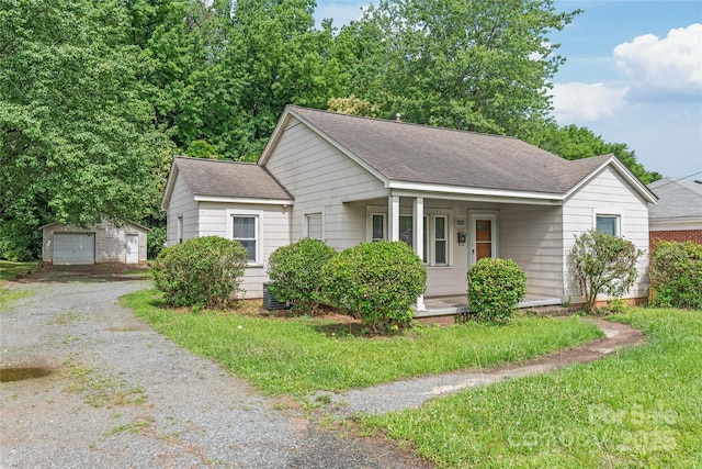 2722 Eastway Dr, Charlotte, NC 28205 - view of front facade with roof with shingles, covered porch, an outdoor structure, and a detached garage