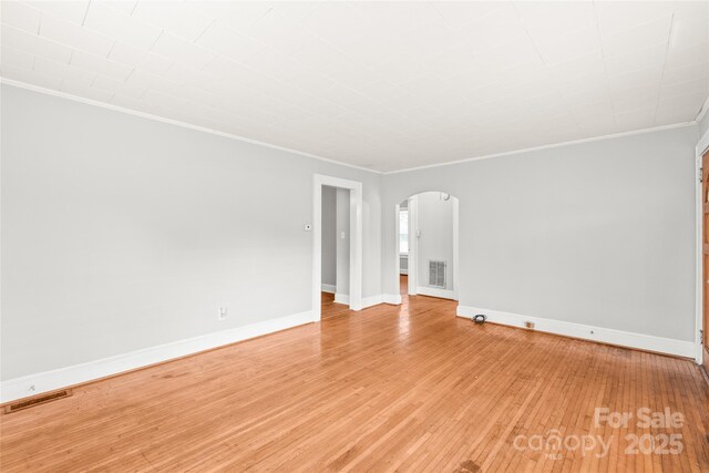 2722 Eastway Dr, Charlotte, NC 28205 - unfurnished room with arched walkways, crown molding, and light wood-type flooring