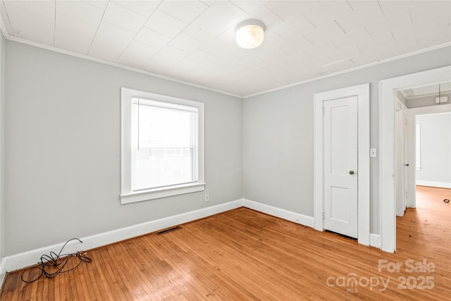 2722 Eastway Dr, Charlotte, NC 28205 - unfurnished room featuring crown molding, light wood-style floors, and attic access