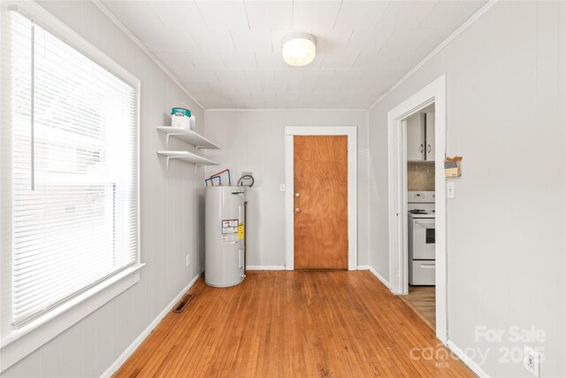 2722 Eastway Dr, Charlotte, NC 28205 - laundry room featuring water heater, crown molding, and light wood-style flooring