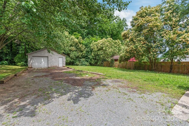 2722 Eastway Dr, Charlotte, NC 28205 - view of yard with a detached garage, an outbuilding, and driveway