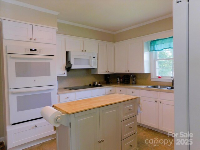 714 Shady Dr, Albemarle, NC 28001 - kitchen with white appliances, a kitchen island, white cabinets, butcher block countertops, and ornamental molding