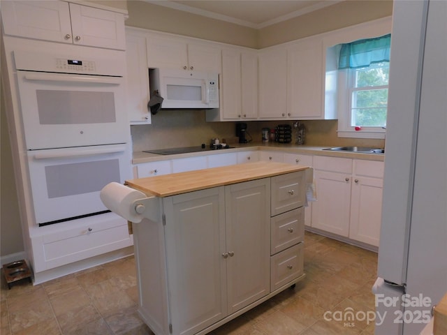 714 Shady Dr, Albemarle, NC 28001 - kitchen with white appliances, a center island, white cabinets, and ornamental molding