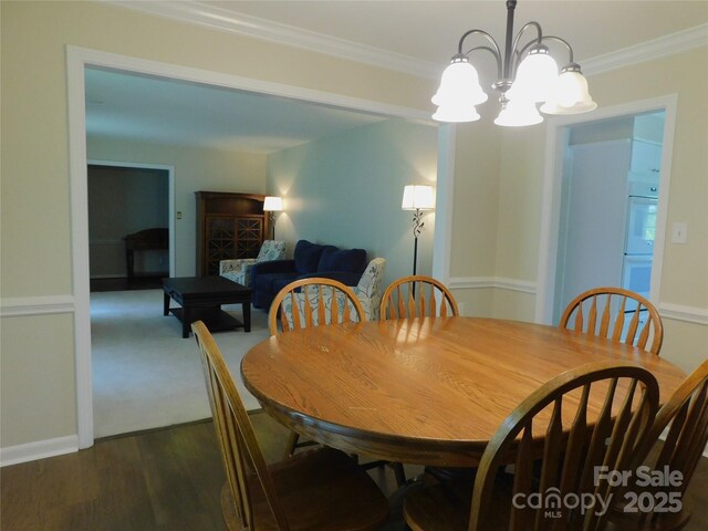714 Shady Dr, Albemarle, NC 28001 - dining area with a chandelier, crown molding, and dark wood-type flooring