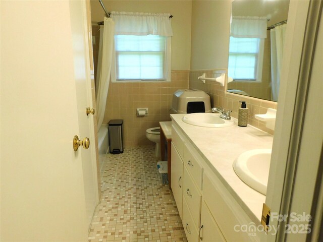 714 Shady Dr, Albemarle, NC 28001 - full bathroom featuring double vanity, plenty of natural light, tile patterned floors, shower / bath combo, and a wainscoted wall