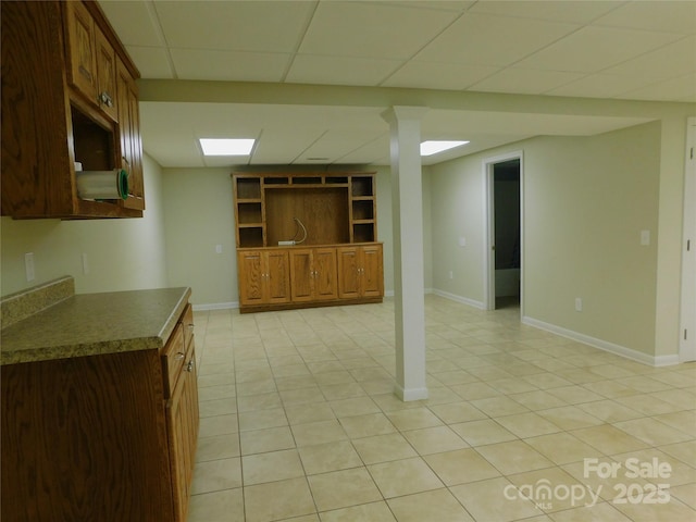 714 Shady Dr, Albemarle, NC 28001 - kitchen with light tile patterned floors, a drop ceiling, dark countertops, and brown cabinets