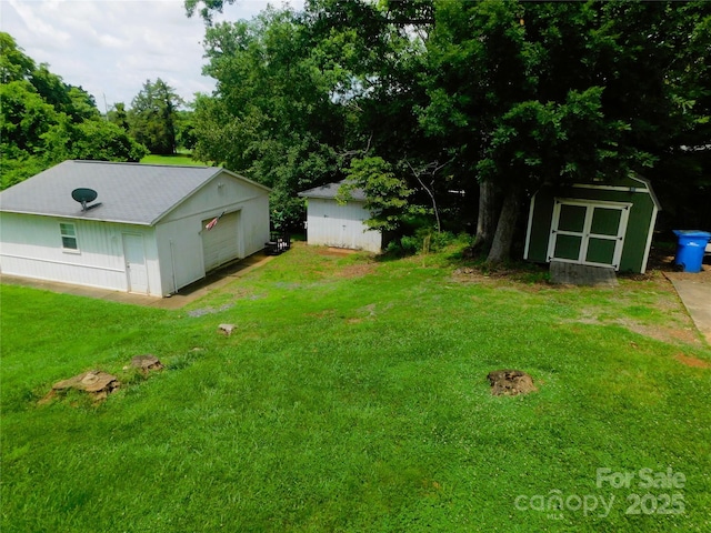 714 Shady Dr, Albemarle, NC 28001 - view of green lawn featuring a storage shed and a garage