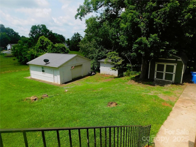 714 Shady Dr, Albemarle, NC 28001 - view of green lawn with a detached garage and a shed