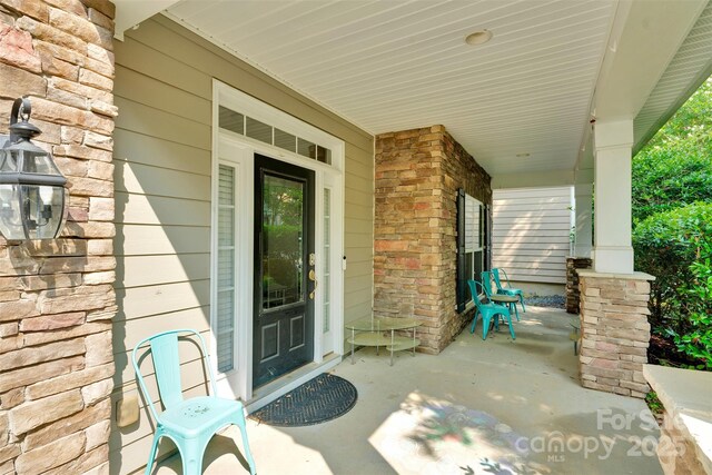 11538 Ardrey Crest Dr, Charlotte, NC 28277 - view of exterior entry with covered porch and stone siding