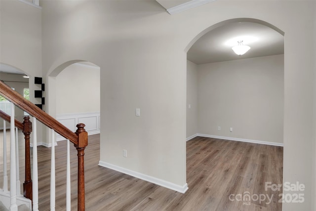11538 Ardrey Crest Dr, Charlotte, NC 28277 - foyer with light wood-style floors, stairs, arched walkways, and crown molding