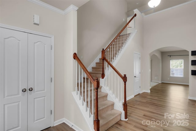 11538 Ardrey Crest Dr, Charlotte, NC 28277 - entrance foyer with arched walkways, crown molding, wood finished floors, and stairs