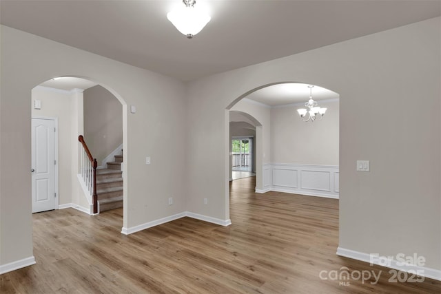 11538 Ardrey Crest Dr, Charlotte, NC 28277 - unfurnished room featuring wood finished floors, crown molding, stairway, and arched walkways