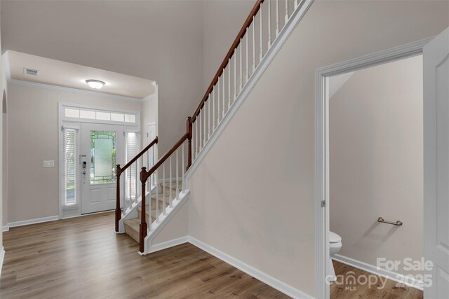 11538 Ardrey Crest Dr, Charlotte, NC 28277 - foyer entrance featuring stairway, wood finished floors, crown molding, and a high ceiling