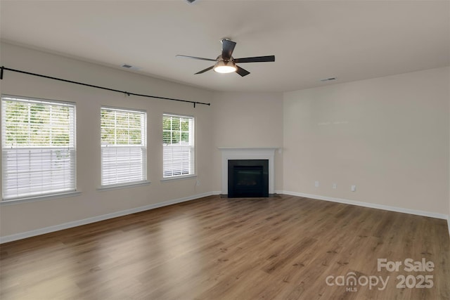 11538 Ardrey Crest Dr, Charlotte, NC 28277 - unfurnished living room featuring ceiling fan, wood finished floors, and a fireplace with flush hearth