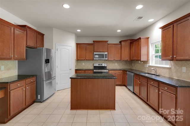 11538 Ardrey Crest Dr, Charlotte, NC 28277 - kitchen featuring stainless steel appliances, a center island, backsplash, light tile patterned floors, and dark stone counters
