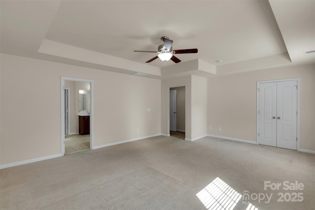 11538 Ardrey Crest Dr, Charlotte, NC 28277 - unfurnished bedroom featuring a raised ceiling, light colored carpet, ensuite bath, and a ceiling fan
