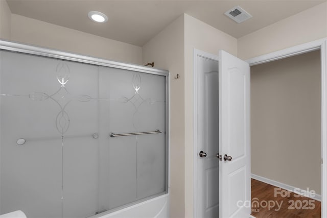 11538 Ardrey Crest Dr, Charlotte, NC 28277 - bathroom with wood finished floors and combined bath / shower with glass door