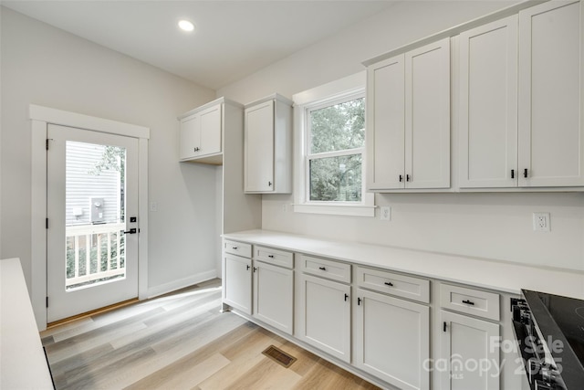 513 Sacco St, Belmont, NC 28012 - kitchen featuring light wood-style flooring, light countertops, white cabinets, recessed lighting, and stovetop