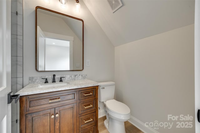 513 Sacco St, Belmont, NC 28012 - bathroom with vanity, lofted ceiling, and wood finished floors