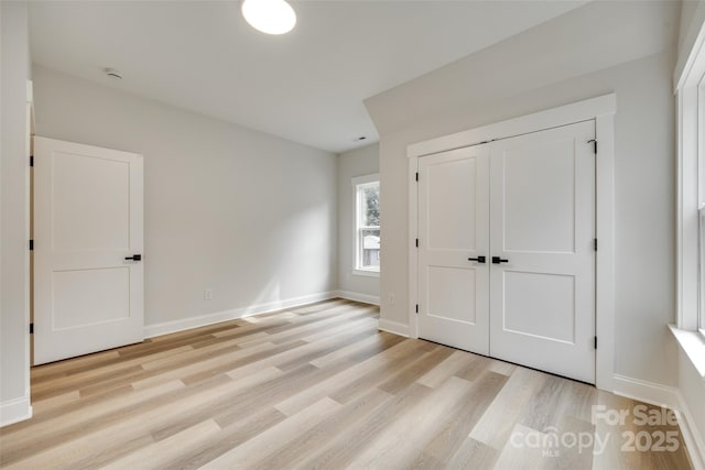 513 Sacco St, Belmont, NC 28012 - unfurnished bedroom featuring light wood finished floors and a closet