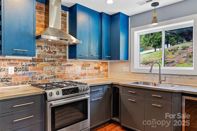 344 Hemlock Springs Trl, Weaverville, NC 28787 - kitchen with wall chimney range hood, stainless steel gas range, blue cabinets, light countertops, and tasteful backsplash