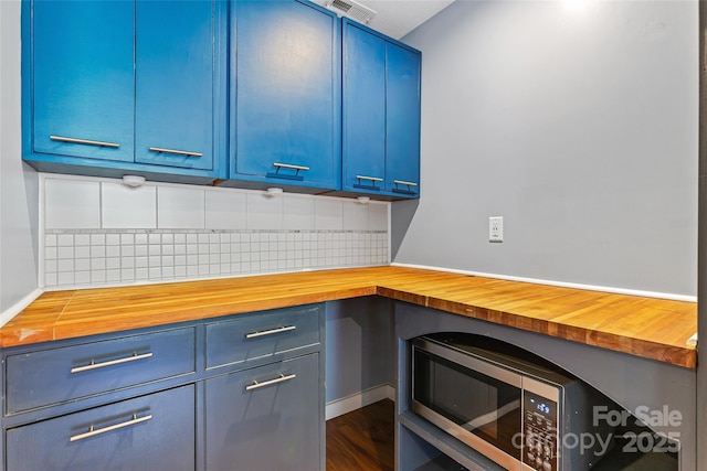 344 Hemlock Springs Trl, Weaverville, NC 28787 - kitchen with wood counters, blue cabinetry, stainless steel microwave, and decorative backsplash