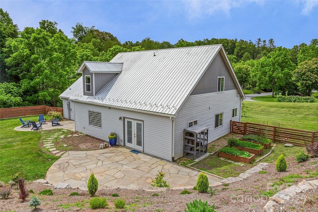 344 Hemlock Springs Trl, Weaverville, NC 28787 - rear view of house with french doors, a patio, a fire pit, a metal roof, and a vegetable garden