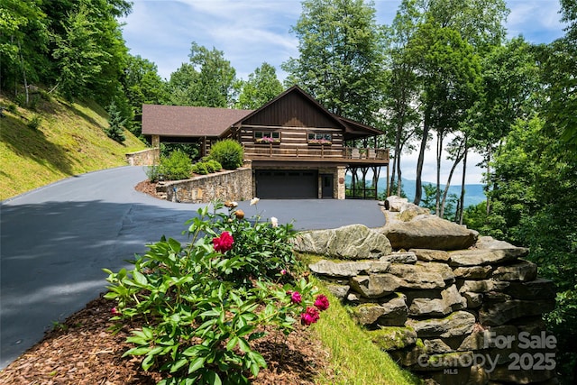 242 Anisidi Trl, Maggie Valley, NC 28751 - log cabin featuring driveway, an attached garage, and stone siding