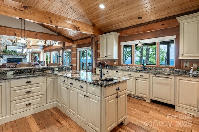 242 Anisidi Trl, Maggie Valley, NC 28751 - kitchen with wood ceiling, a fireplace, dark stone counters, light wood finished floors, and open floor plan