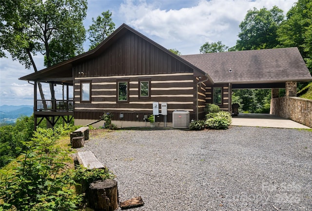 242 Anisidi Trl, Maggie Valley, NC 28751 - log-style house featuring driveway, a shingled roof, an attached carport, and a mountain view