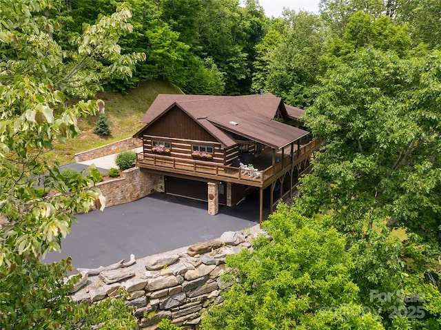 242 Anisidi Trl, Maggie Valley, NC 28751 - view of front of house with a wooden deck, stone siding, a patio area, and driveway