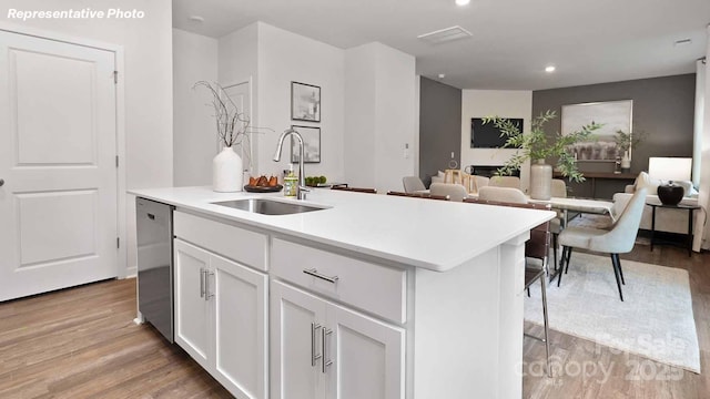 780 14th Avenue Ct NE, Hickory, NC 28601 - kitchen featuring stainless steel dishwasher, light wood-style floors, an island with sink, white cabinets, and light countertops