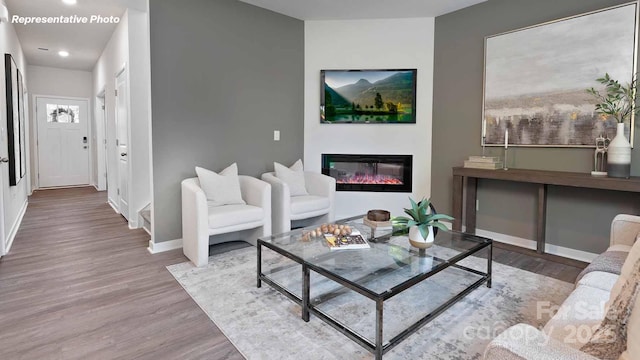 780 14th Avenue Ct NE, Hickory, NC 28601 - living area featuring wood finished floors, a glass covered fireplace, and recessed lighting
