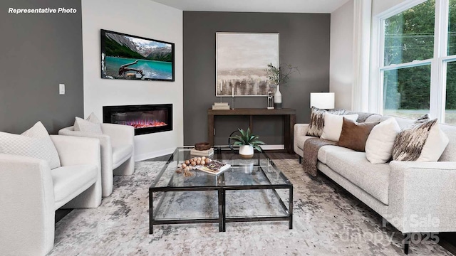 780 14th Avenue Ct NE, Hickory, NC 28601 - living room featuring a glass covered fireplace and wood finished floors