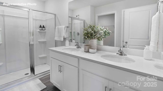 780 14th Avenue Ct NE, Hickory, NC 28601 - bathroom featuring a shower stall, double vanity, and wood finished floors