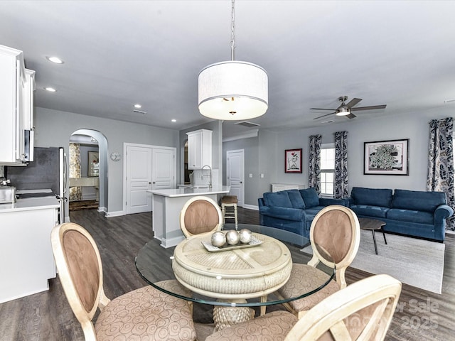 2003 Trigger Dr, Indian Trail, NC 28079 - dining area featuring arched walkways, a ceiling fan, dark wood-style floors, and recessed lighting