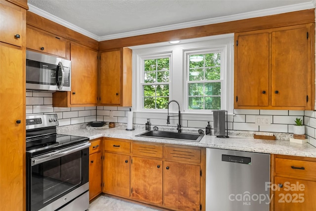 302 White St, Morganton, NC 28655 - kitchen featuring appliances with stainless steel finishes, ornamental molding, decorative backsplash, brown cabinetry, and a textured ceiling